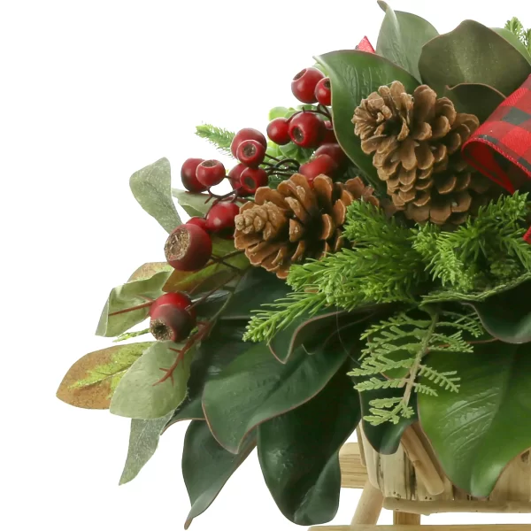 Magnolia, Cedar and Berry Holiday Arrangement in a Wooden Sled
