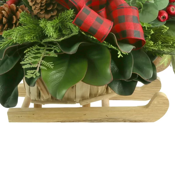 Magnolia, Cedar and Berry Holiday Arrangement in a Wooden Sled