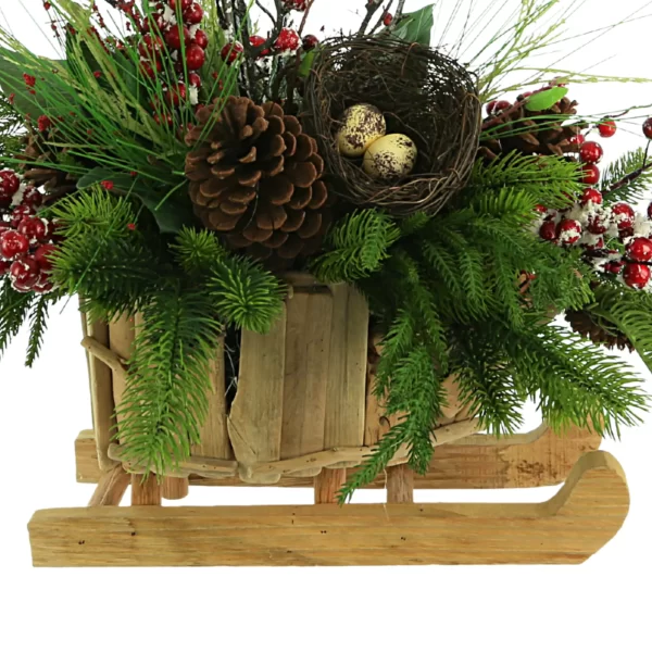 Evergreen Holiday Arrangement with Snowy Berries and Bird’s Nest in a Wooden Sleigh