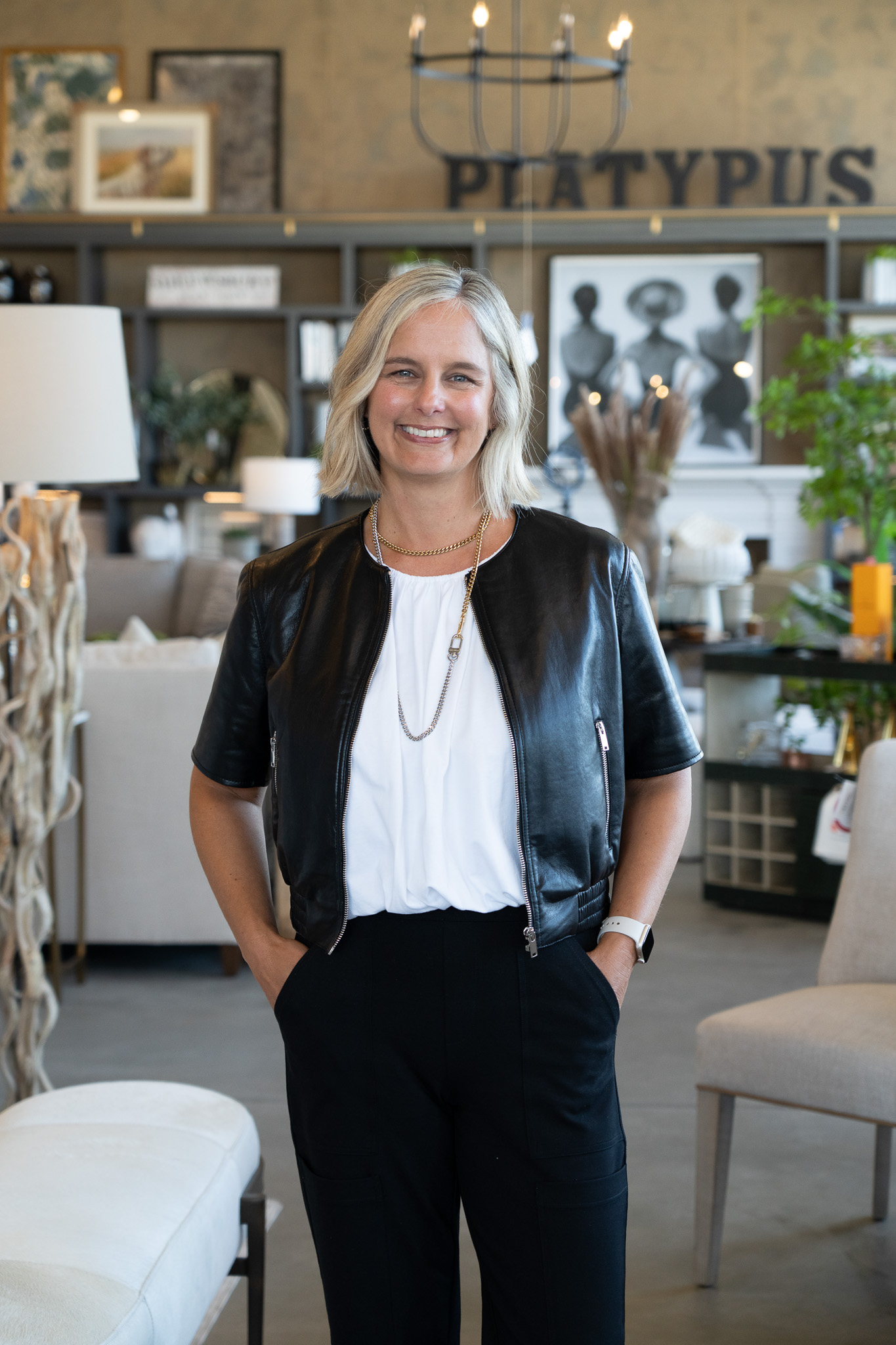 Platypus Home design team member smiling inside the furniture showroom