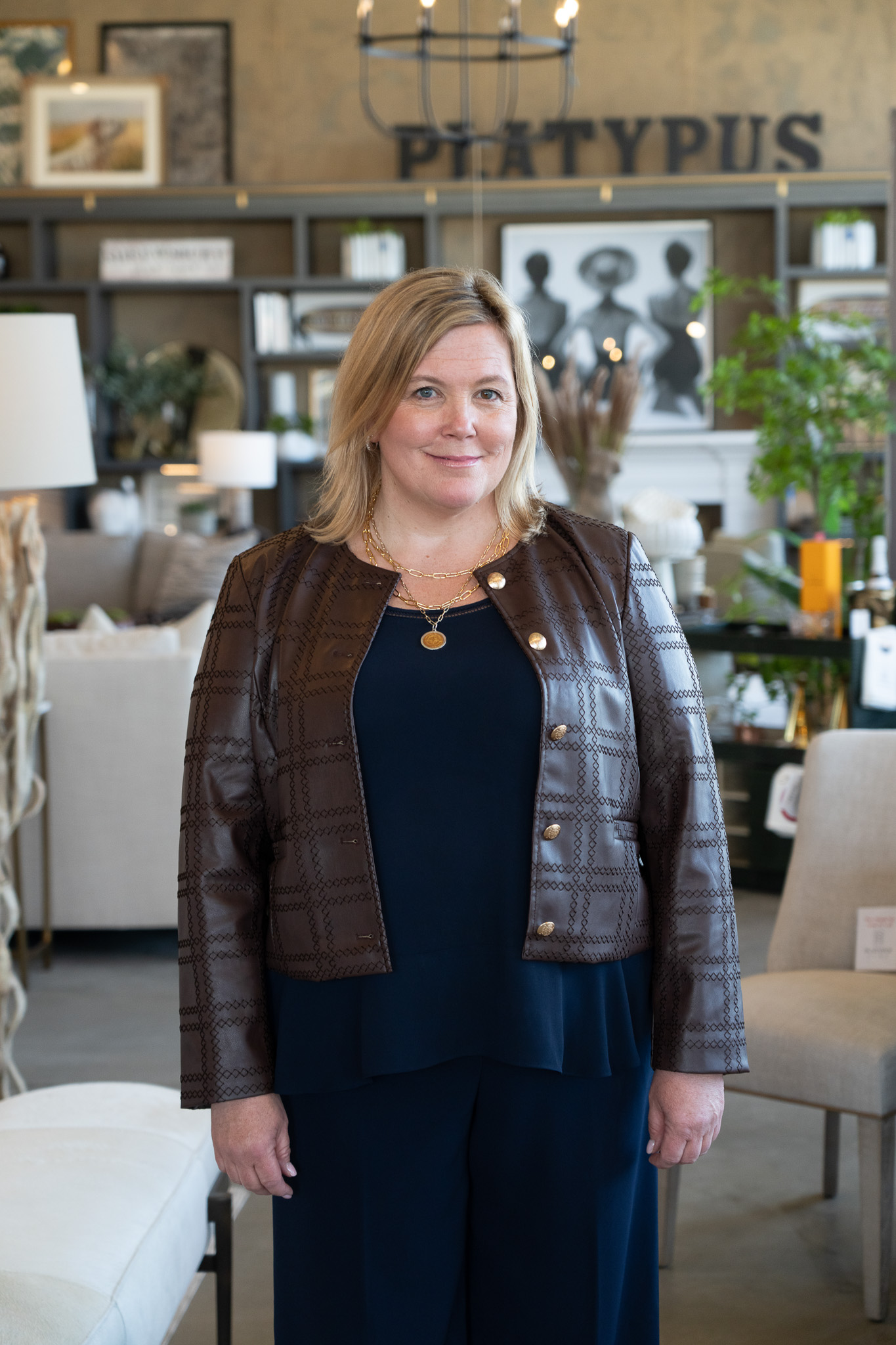 Platypus Home design team member smiling inside the furniture showroom