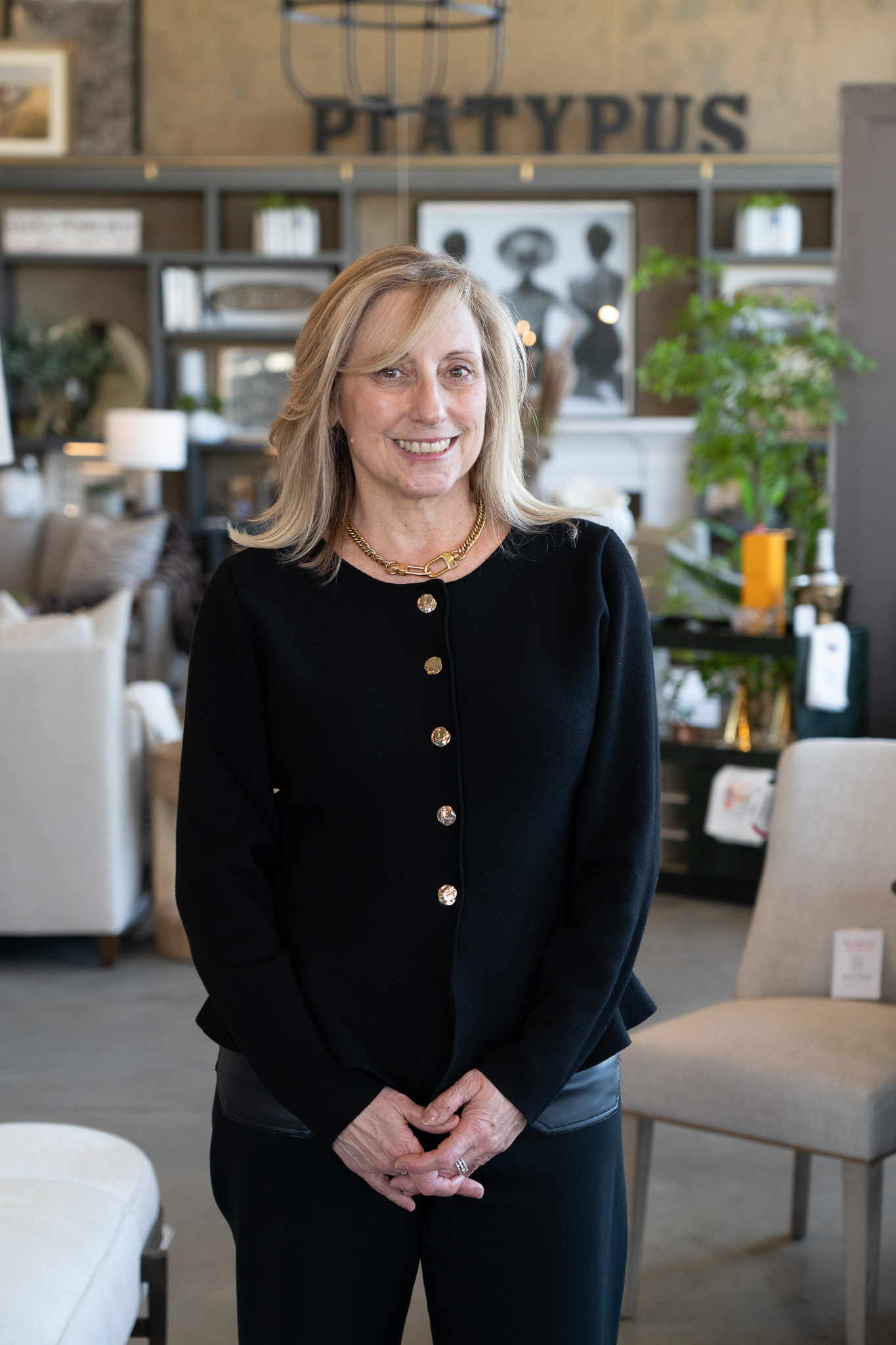 Platypus Home design team member smiling inside the furniture showroom