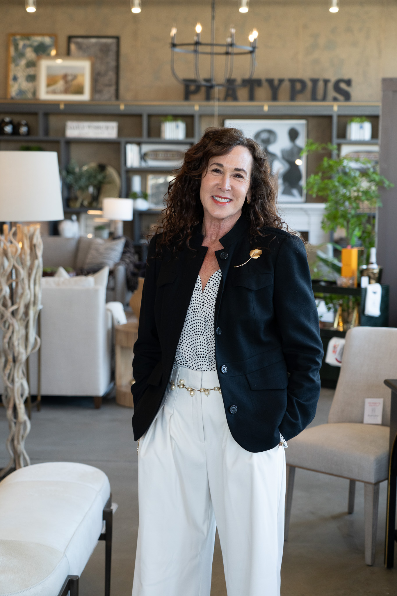 Platypus Home design team member smiling inside the furniture showroom