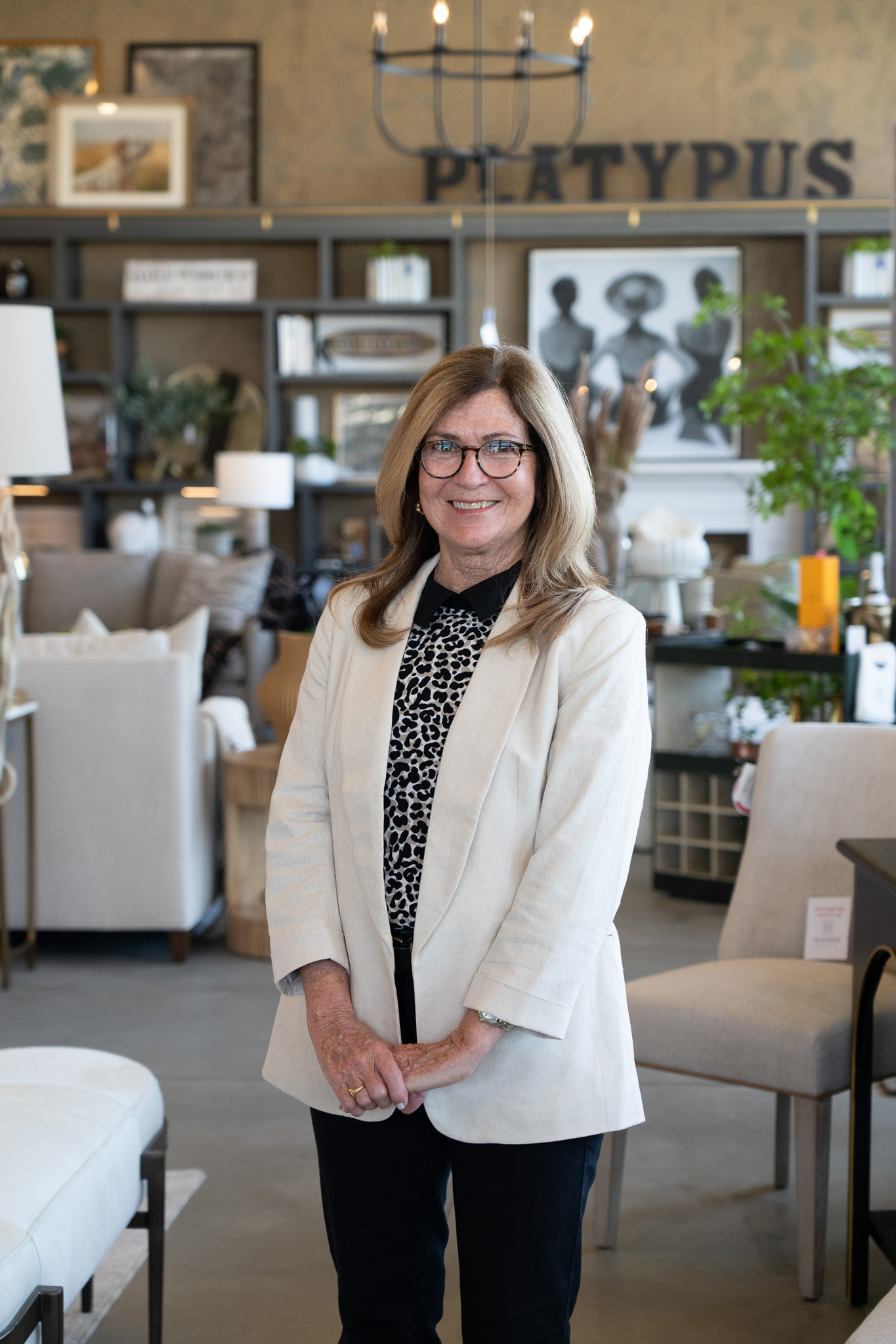 Platypus Home design team member smiling inside the furniture showroom