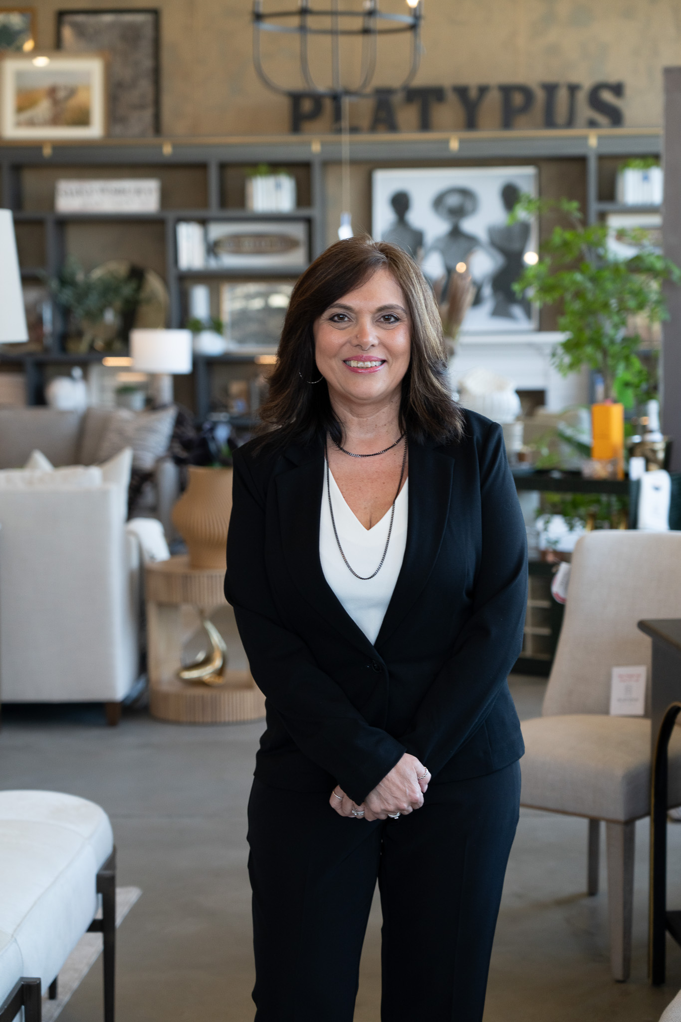 Platypus Home design team member smiling inside the furniture showroom