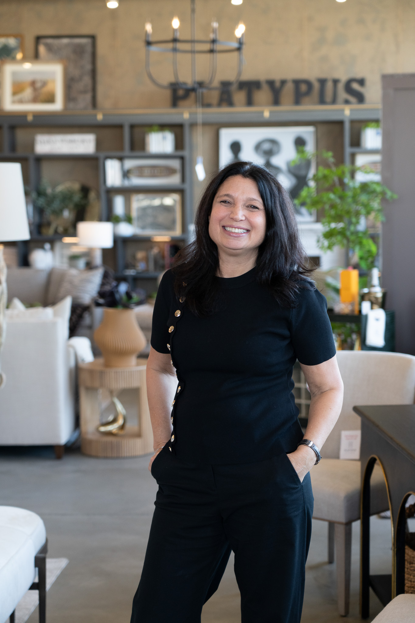 Platypus Home design team member smiling inside the furniture showroom