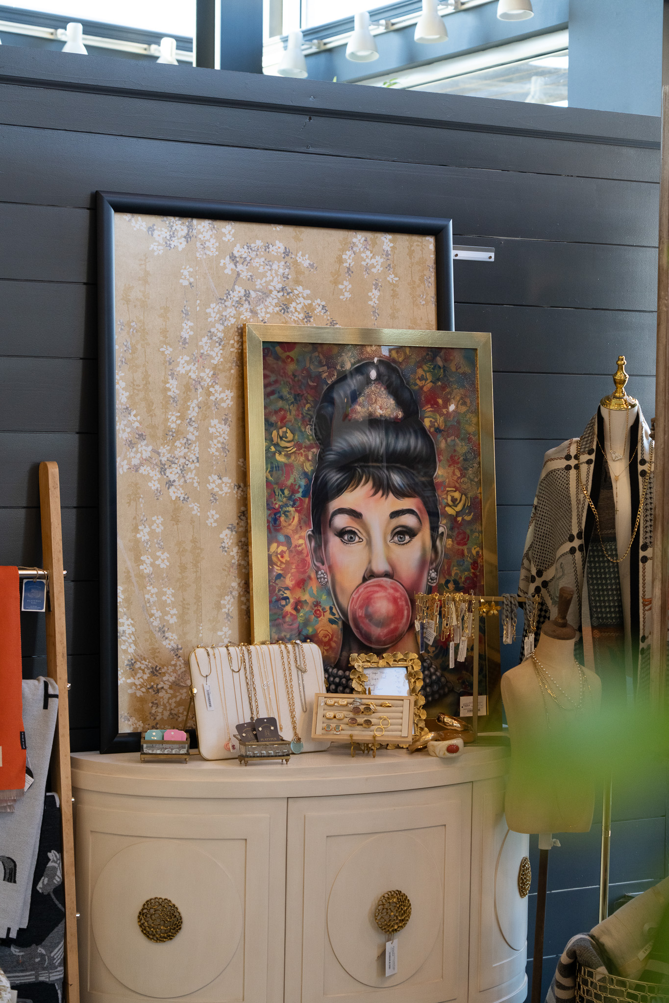 Painting, jewelry, and accessories inside NJ furniture showroom