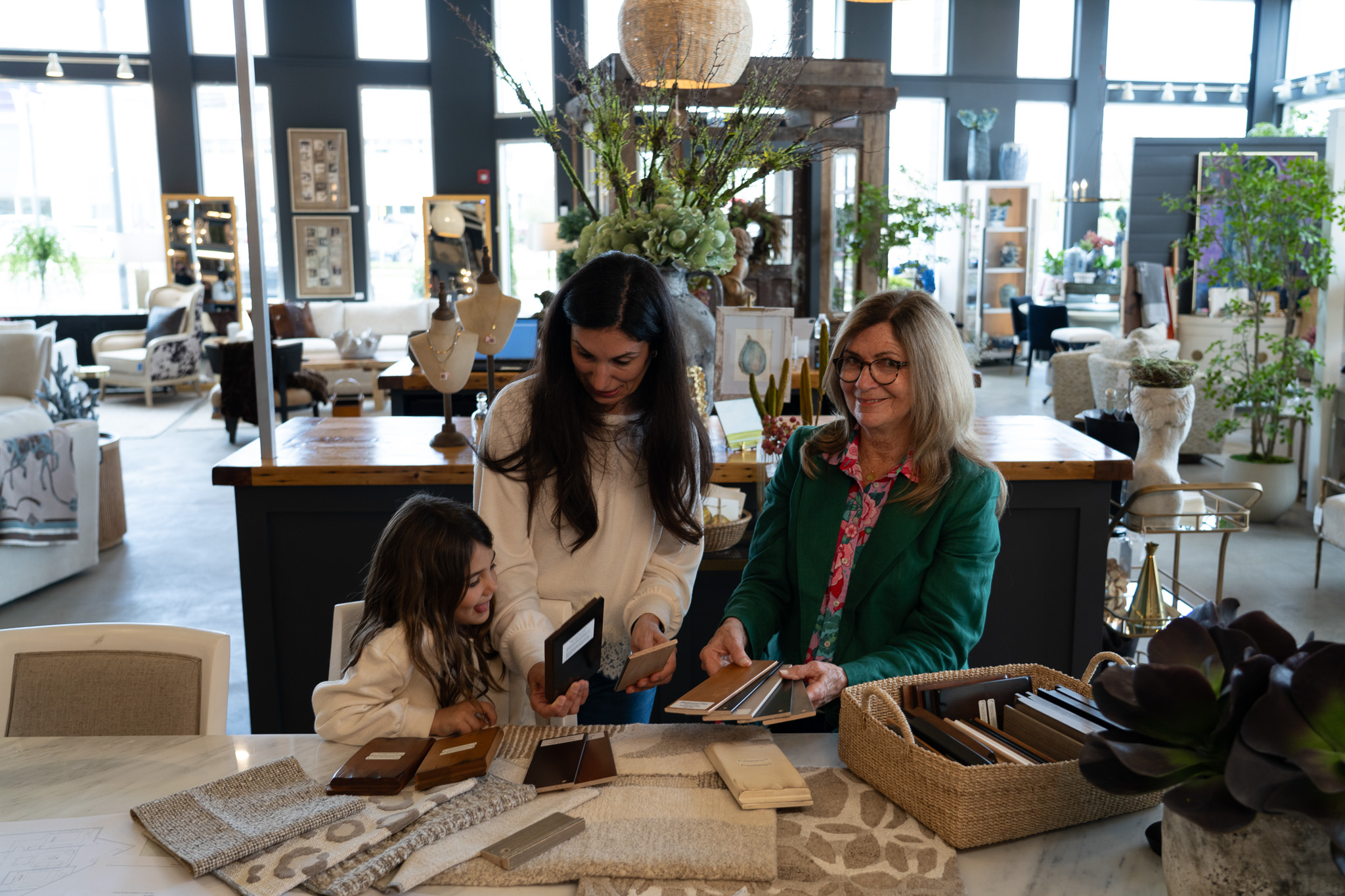 Interior designer smiling while working with customer and child at Platypus Home