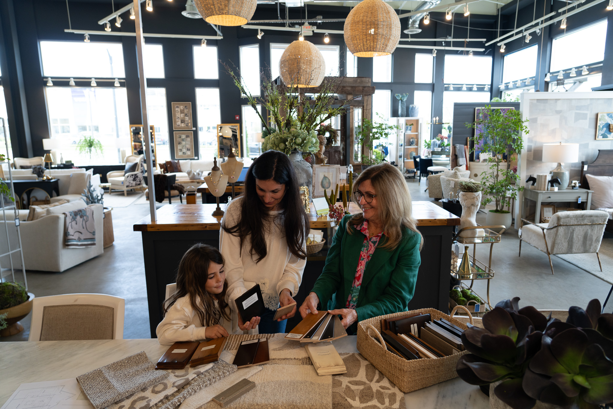 Interior designer working with a customer and her daughter at Platypus Home